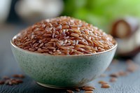Raw brown flax seeds in ceramic bowl on dark background, healthy organic superfood rich in omega-3 fatty acids and fiber, macro food photography.
