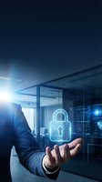 Businessman holding glowing digital padlock hologram in modern office representing cybersecurity data protection and network security solutions.