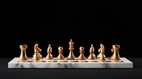 Elegant golden chess pieces arranged in starting position on white marble board against black background, showcasing strategic game setup.