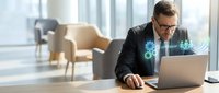 Professional businessman working on laptop with digital technology interface in modern office environment for business presentations and corporate communications.