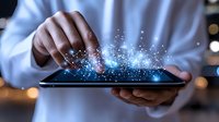 Digital transformation concept with hands touching tablet screen, glowing network connections and sparkles emerging in dark ambient lighting.