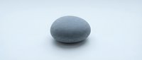 Smooth gray stone pebble isolated on white background, suitable for wellness, spa, meditation, and design projects.