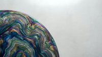 Abstract fluid art with swirling multicolored patterns in blues, greens, and purples creating organic flowing shapes on neutral background for modern decor.