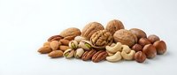 Mixed nuts collection including almonds walnuts cashews pecans hazelnuts and pistachios arranged on white background for healthy snacking and cooking.
