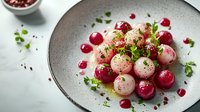 Gourmet radish salad with fresh herbs and pomegranate seeds on elegant ceramic plate, perfect for restaurant menu photography and culinary presentations.