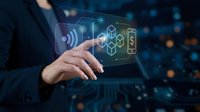 Businessman hand touching digital holographic icons representing wireless technology, blockchain, cryptocurrency and smart home automation systems.