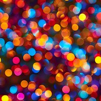 Vibrant defocused bokeh lights creating colorful abstract background with orange, blue, and pink glowing circles. Festive blurred pattern for holiday designs.