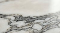 Natural marble stone surface with elegant gray and white veining patterns for luxury interior design and architectural applications.