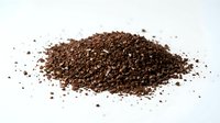Ground coffee beans pile isolated on white background for brewing espresso cappuccino latte drinks and cafe menu designs.