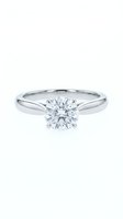 Classic solitaire diamond engagement ring with round brilliant cut stone in white gold setting isolated on white background for jewelry design.