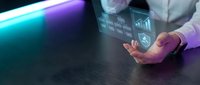 Professional businessman holding holographic digital interface with data analytics and charts in modern office environment for business technology presentations.