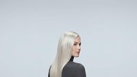 Young woman with long platinum blonde straight hair and fair complexion, wearing black turtleneck, isolated on white background for design and commercial use.