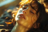 Sensual close-up portrait of young Asian woman in golden sunlight, with wet effect skin and tousled dark hair, perfect for beauty and fashion advertising.