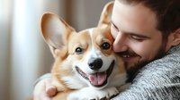 Young Caucasian man with beard embracing happy Welsh Corgi dog with bright expression. Pet companionship concept for animal care websites.