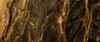 Luxurious dark marble surface with golden veins and striations, ideal for interior design, backgrounds, and premium product presentations.