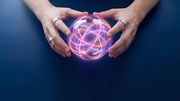 Hands protecting glowing pink energy sphere with geometric patterns on dark blue background for technology and innovation concepts.