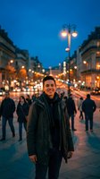 Young Hispanic man smiling on busy city street at dusk with warm lights and blurred traffic creating bokeh effect in urban evening atmosphere.