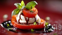Fresh caprese salad with layered tomatoes, mozzarella, basil leaves and balsamic glaze drizzle on dark background, macro food photography.
