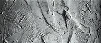 Textured gray concrete surface with rough brushstrokes and cracks showing weathered cement wall background for industrial design projects.