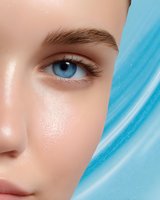 Close-up partial face view showing bright blue eye, natural eyebrow, and flawless skin against turquoise abstract background, highlighting beauty and cosmetic features.