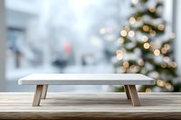 Empty marble display stand on wooden surface with blurred Christmas tree and bokeh lights in background for product presentation.
