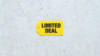 Yellow price tag with LIMITED DEAL text on concrete background, retail sale promotion concept for marketing and advertising.