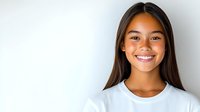 Young Asian woman with bright genuine smile wearing white t-shirt against light background. Portrait with copy space for wellness, dental care or lifestyle design.