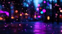 Magical night bokeh effect with glowing pink and orange lights against dark background, creating dreamy atmospheric blur for festive designs and backgrounds.