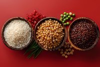 Variety of raw rice, chickpeas and red rice in wooden bowls on red background with fresh herbs and chili pepper for healthy cooking and food styling.