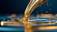 Golden liquid splash creating elegant crown formation with droplets and ripples against dark blue background. Luxury fluid motion for premium product advertising.
