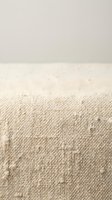 Soft beige knitted wool fabric texture with natural fibers and cozy warmth for home decor and fashion design projects.