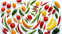 Fresh assorted hot and sweet peppers, chili peppers and bell peppers isolated on white background for cooking, recipe, food design and culinary projects.