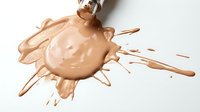 Coffee splash with droplets and splatter isolated on white background, suitable for beverage advertising, packaging design, and creative projects.