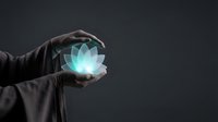 Hand holding glowing lotus flower with turquoise light against dark background, representing wellness, spirituality, meditation, healing energy and mindfulness for wellness industry.