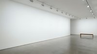 Empty modern art gallery interior with white walls, polished concrete floor and track lighting system for exhibitions and contemporary artwork display.