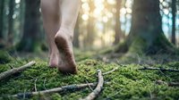 Barefoot person walking on soft green moss in sunlit forest connecting with nature for mindfulness meditation and grounding wellness practices.