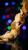 Golden crispy potato chips falling with colorful bokeh lights background for snack food advertising and party celebration concepts.
