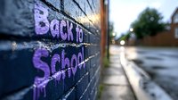Purple graffiti text on brick wall reads Back to School with urban street background and bokeh lights creating atmospheric educational concept.