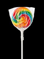 Rainbow swirl lollipop in plastic wrap on a stick, isolated on transparent background, ready for stickers, t-shirt design, clipart, and print on demand use.