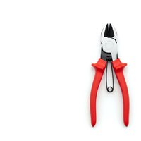 Professional pliers with red handles isolated on white background for construction and repair work projects.