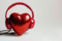 Red heart-shaped decoration wearing headphones against white background, romantic music concept for valentines day and love songs.