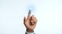 Business professional finger touching glowing lightbulb icon representing innovation, creativity and bright ideas for corporate solutions.