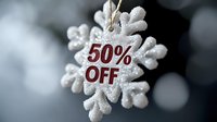 White glittery snowflake ornament with 50% off text in red, hanging against dark background with bokeh lights, seasonal winter sale and holiday shopping concept.