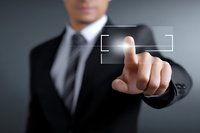 Businessman in formal suit touching virtual interface, demonstrating digital technology interaction in corporate environment.