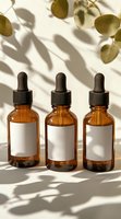 Amber glass dropper bottles with blank white labels cast natural leaf shadows on white background. Minimalist skincare packaging mockup for essential oils.