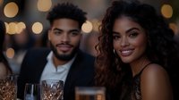 Young African American couple enjoying romantic dinner date at upscale restaurant with bokeh lights creating intimate atmosphere for anniversary celebration.