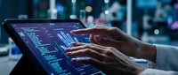 Professional analyzing financial data on tablet with digital charts and graphs in modern office environment for business intelligence and market research.
