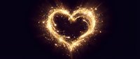 Golden heart shape made of glowing sparks and light trails on dark background for romantic designs and Valentine's Day celebrations.