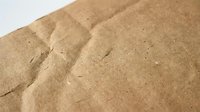 Natural brown sand texture with rippled patterns and fine granular surface for construction, landscaping and desert themed projects.