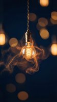 Vintage Edison bulb suspended on brass chain with glowing filament and warm bokeh lights in dark background, suitable for interior design and lighting concepts.